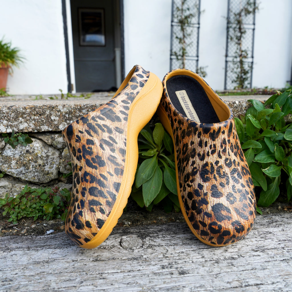 Leopard printed clogs, positioned on the back door